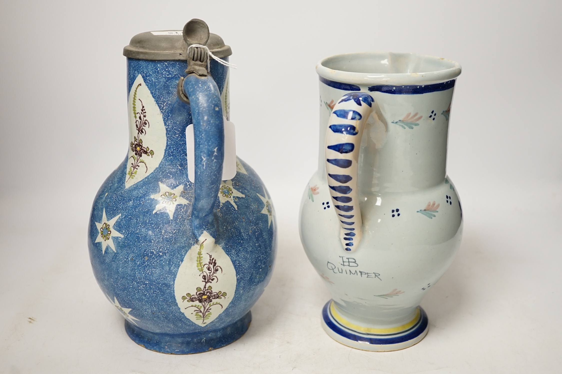An 18th / 19th century Brussels faience jug and a French Quimper faience pottery jug, largest 25cm high. Condition - fair to good